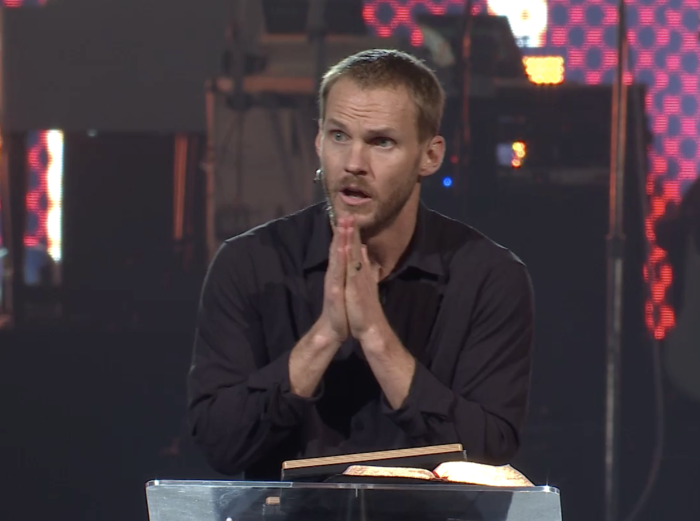 Evangelical Baptist pastor David Platt pleads with an audience of thousands of adults and teens to for them to spread the Gospel to unreached people at the annual Passion 2022 Conference in Georgia. 