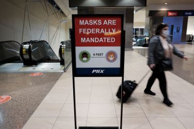 People walk through Sky Harbor International Airport in Phoenix where new COVID-19 cases are down but health experts warn cases may rise with the introduction of the omicron strain on December 18, 2021 in Phoenix, Arizona. According to the Arizona Department of Health Services, since mid-December 2020 over 14,000 people have died of COVID-19 in Arizona. Arizona Governor Doug Ducey has signed an executive order banning local governments from imposing the vaccine requirements. Arizona does not yet have a mask mandate and mask use is sporadic.