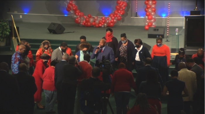 Members of Empowerment Temple in Baltimore, Maryland, gather around in prayer for Marilyn Mosby, the State's Attorney for Baltimore City, during a worship service on Jan. 16, 2022. 