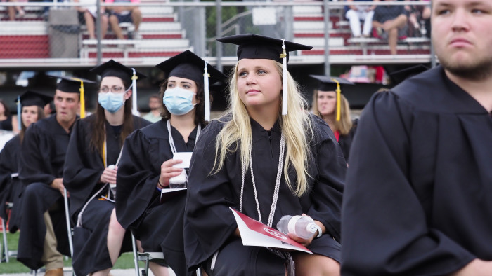 Students attend a commencement ceremony at Northwestern College held at the school's football stadium in Orange City, Iowa in May 2020. 