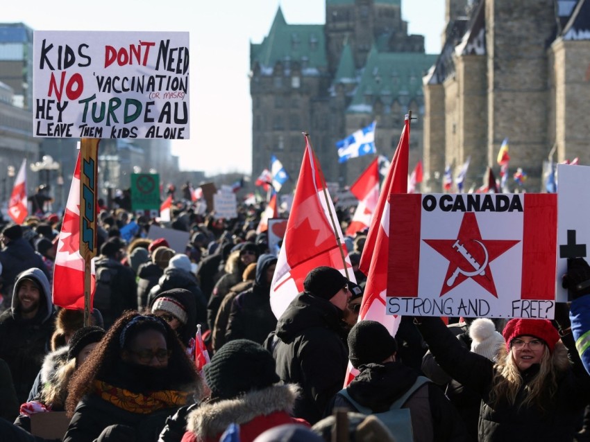 Supporters of the Freedom Convoy protest Covid-19 vaccine mandates and restrictions in front of Parliament on January 29, 2022 in Ottawa, Canada. - Hundreds of truckers drove their giant rigs into the Canadian capital Ottawa on Saturday as part of a self-titled "Freedom Convoy" to protest vaccine mandates required to cross the US border.