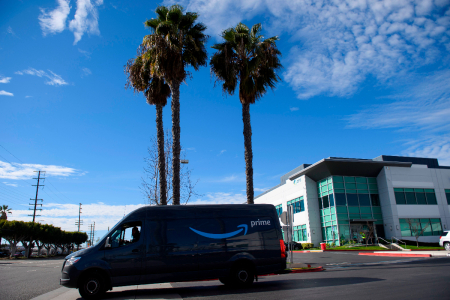 An Amazon.com Inc. van delivery driver departs a distribution facility on February 2, 2021 in Hawthorne, California.
