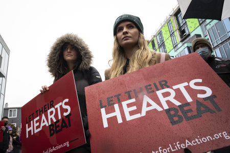 Pro-life activists protest outside of a Planned Parenthood clinic on January 20, 2022, in Washington, D.C. The protest was organized by the Purple Sash Revolution and Priests for Life, calling for defunding and replacing of Planned Parenthood. On Friday, thousands of anti-abortion activists are expected in Washington, DC for the annual March For Life.