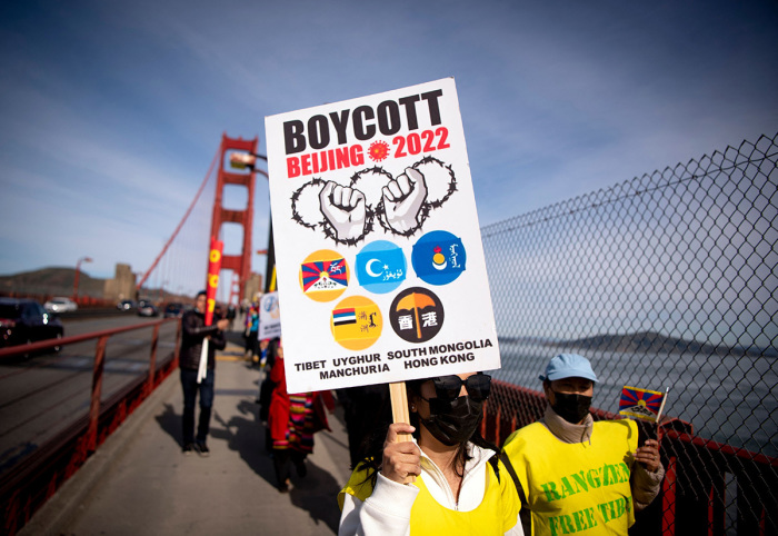 A protester holds up a 'Boycott Beijing 2022' sign after marching across the Golden Gate Bridge during a demonstration against the 2022 Beijing winter Olympic Games, in San Francisco, California, on February 3, 2022. Activists protested against the many human rights abuses of the Chinese Communist Party and called for a boycott of the 2022 Winter Olympics due to be held in Beijing. United States, Britain, Canada and Australia are among countries staging a diplomatic boycott over China's human rights record, particularly the fate of the Muslim Uyghur minority in Xinjiang. 