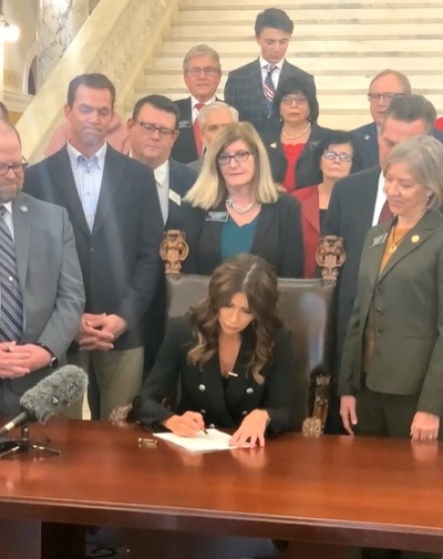 South Dakota Gov. Kristi Noem signs Senate Bill 46 into law on Feb. 3, 2022. The measure prohibits men from competing in women's sports.