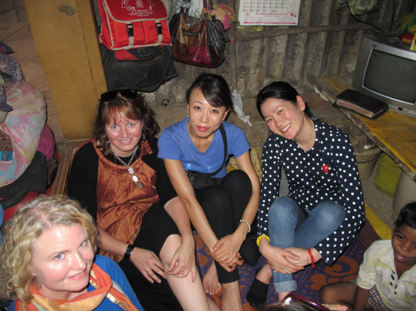Members of Redeemer Presbyterian Church in New York City pose for a photo while having tea with a family in a slum district outside of Mumbai, India, during a 2014 missions trip. From left to right: Katie Sullivan, Christina Stanton, Haejin Shim, Nelli Kim.