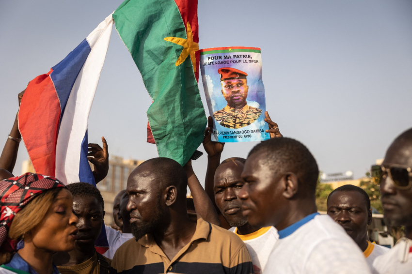 Demonstrators hold a photo of Lieutenant Colonel Paul-Henri Sandaogo Damiba the leader of the mutiny and of the Patriotic Movement for the Protection and the Restauration (MPSR) as they gather to show support to the military in Ouagadougou, on February 19, 2022. (Photo by OLYMPIA DE MAISMONT / AFP) (Photo by OLYMPIA DE MAISMONT/AFP via Getty Images)