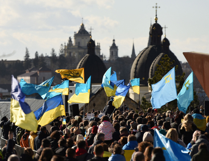 People take part in a rally on February 19, 2022, in the center of the western Ukraine city of Lviv to show their unity as fears mount that Russia could invade its neighbor in the coming days. 