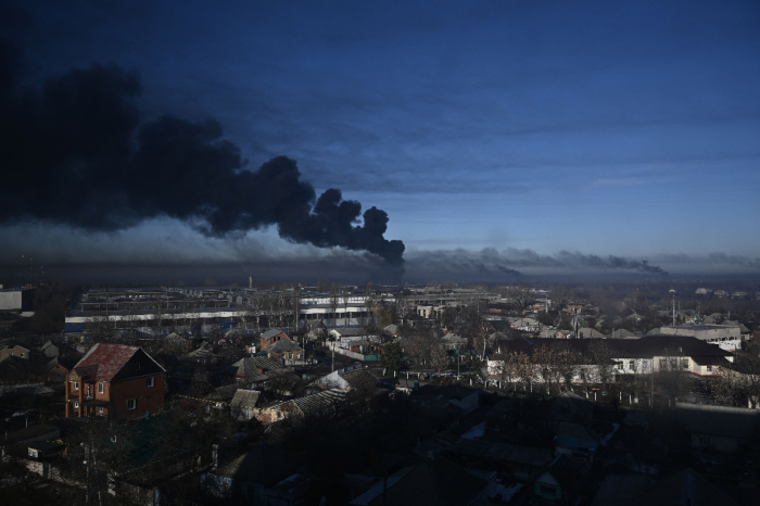 Black smoke rises from a military airport in Chuguyev near Kharkiv on February 24, 2022. Russian President Vladimir Putin announced a military operation in Ukraine today with explosions heard soon after across the country and its foreign minister warning a 'full-scale invasion' was underway. 