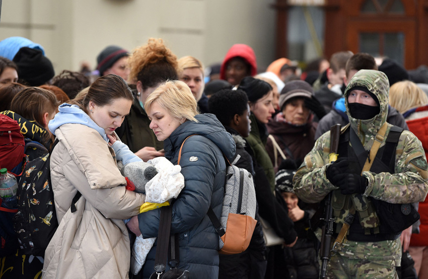 People wait for a train to Poland at the railway station of the western Ukrainian city of Lviv on February 26, 2022. - Ukrainian forces repulsed a Russian attack on Kyiv but 