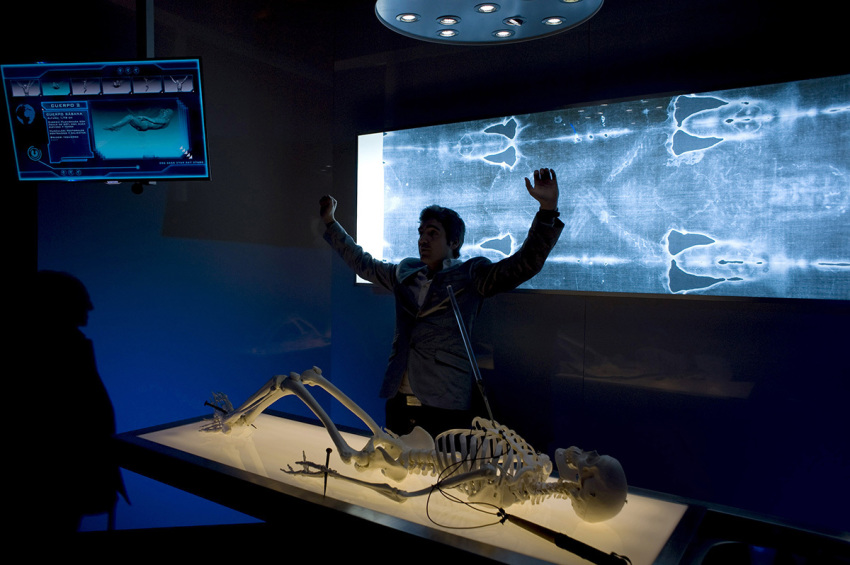 An official gestures as he speaks next to a facsimile of "The Shroud of Turin" at the Cathedral of Malaga, on February 20, 2012.