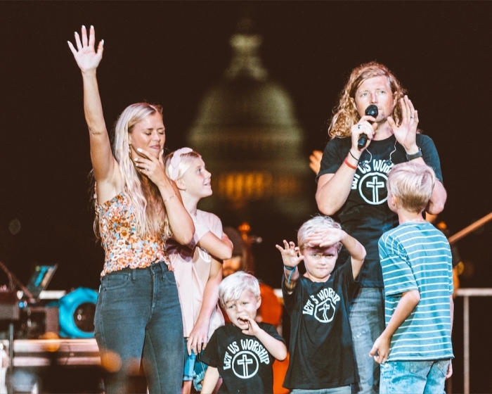 Sean Feucht and family appear on stage during the 'Let us Worship' Tour in Washington, D.C. in 2022.