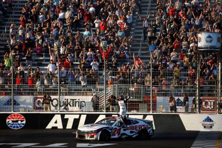 William Byron, driver of the #24 Liberty University Chevrolet, celebrates after winning the NASCAR Cup Series Folds of Honor QuikTrip 500 at Atlanta Motor Speedway on March 20, 2022, in Hampton, Georgia. 
