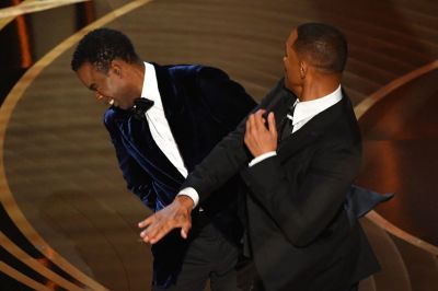 Actor Will Smith (R) slaps actor Chris Rock onstage during the 94th Oscars at the Dolby Theatre in Hollywood, California, on March 27, 2022. ROBYN BECK/AFP via Getty Images) 