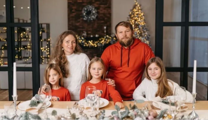Ellina and Sergey Lesnik and their three children pose for a photo during the Christmas season.