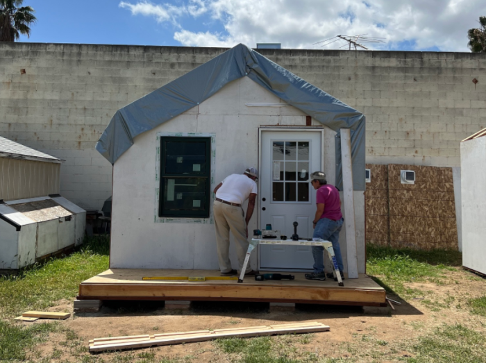 Meridian Baptist Church volunteers work on a nearly complete cabin intended to temporarily house homeless people in El Cajon, California.