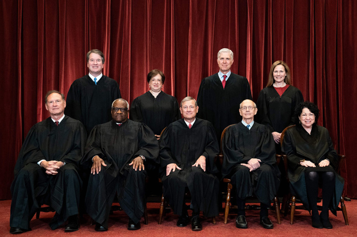 Seated from left: Associate Justice Samuel Alito, Associate Justice Clarence Thomas, Chief Justice John Roberts, Associate Justice Stephen Breyer and Associate Justice Sonia Sotomayor, standing from left: Associate Justice Brett Kavanaugh, Associate Justice Elena Kagan, Associate Justice Neil Gorsuch and Associate Justice Amy Coney Barrett pose during a group photo of the Justices at the Supreme Court in Washington, DC on April 23, 2021.