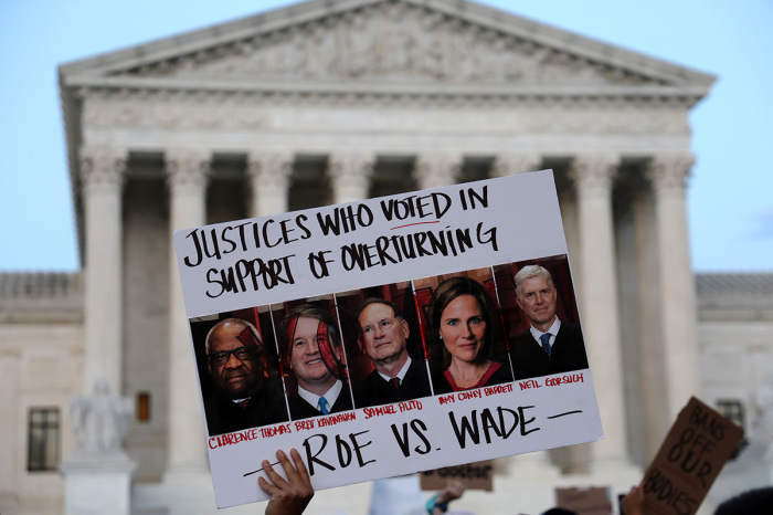 A pro-choice activist holds up a sign during a rally in front of the U.S. Supreme Court in response to the leaked Supreme Court draft decision to overturn Roe v. Wade May 3, 2022, in Washington, D.C. 