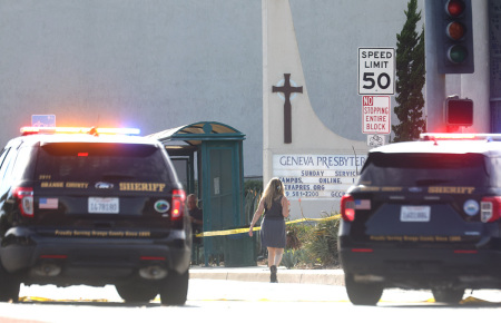 Police vehicles are parked near the scene of a shooting at the Geneva Presbyterian Church on May 15, 2022, in Laguna Woods, California. According to police, the shooting left one person dead, four critically wounded, and one with minor injuries.