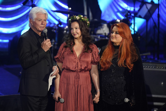(L-R) Larry Strickland, Ashley Judd, and Wynonna Judd speak onstage for Naomi Judd: 'A River Of Time' celebration on May 15, 2022, in Nashville, Tennessee. 