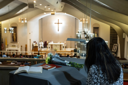 A mourner attends a vigil at Sacred Heart Catholic Church for victims of a mass shooting at Robb Elementary School on May 24, 2022, in Uvalde, Texas. According to reports, 19 students and two adults were killed before the gunman was fatally shot by law enforcement.