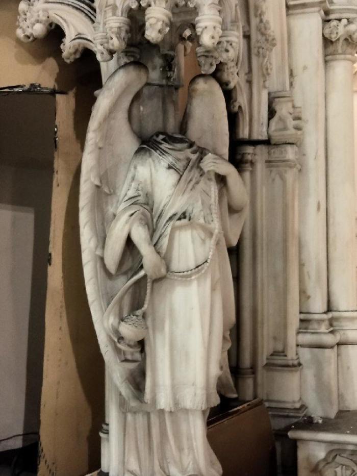 A decapitated angel statue at St. Augustine Roman Catholic Church in the Park Slope neighborhood of Brooklyn, New York .