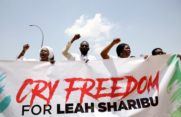 Relatives of schoolgirl Leah Sharibu abducted by Boko Haram Islamists hold a banner to press for her release during an event to mark her 16th birthday and two years in captivity at the Unity Fountain in Abuja, on May 14, 2019. - Leah Sharibu was among over 100 schoolgirls abducted from the Government Girls Secondary School in Dapchi, northeast Nigeria on February 19, 2018. But while schoolmates had been freed, she was held back for refusing to denounce her religion. 
