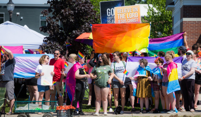 Attendees of Lowell Pride 2021 block the view of protesters at the event in June 2021 in Lowell, Michigan. 