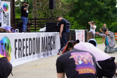 Crowd members bow their heads in reverence of God during a prayer at the Freedom March at the Sylvan Theater in Washington, D.C., on June 11, 2022. 