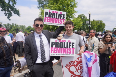 Pro-life feminists held signs high in the air outside the U.S. Supreme Court following the Dobbs v. Jackson Women's Health Organization decision in Washington, D.C., June 24, 2022. 