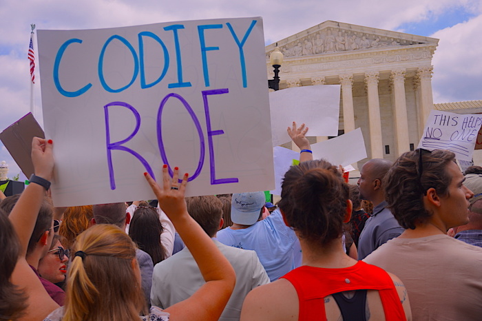 Participants in a rally outside the U.S. Supreme Court in Washington D.C. hold signs expressing their stance on abortion following the decision of Dobbs v. Jackson Women's Health Organization, on June 24, 2022. 