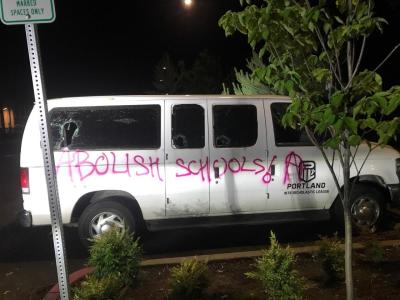 The words 'ABOLISH SCHOOLS' were spray-painted on a public school van. 