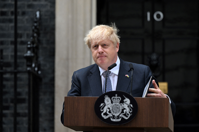 Britain's Prime Minister Boris Johnson makes a statement in front of 10 Downing Street in central London on July 7, 2022. - U.K. Prime Minister Boris Johnson on Thursday quit as Conservative party leader, after three tumultuous years in charge marked by Brexit negotiations, COVID-19 lockdowns and mounting scandals. 