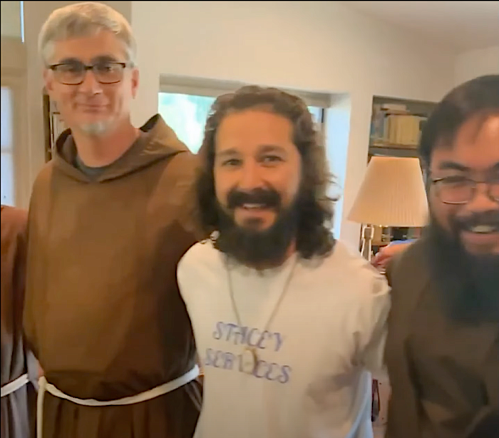 Shia LaBeouf poses with Franciscan Capuchin friars in 2021.
