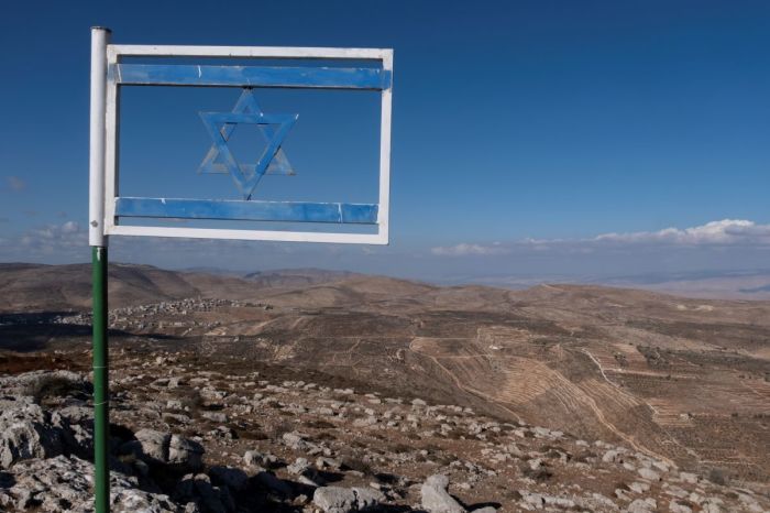 The Israeli flag made from steel placed at Matan Lookout overlooking the hills of Samaria also known as Nablus Mountains located on the Gidonim ridge (a hilltop on which several Jewish settlements are located), above the Israeli settlement of Itamar in the West Bank. 