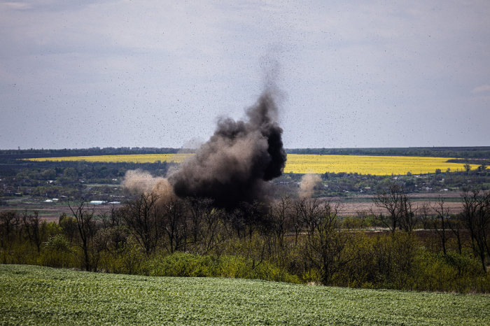Smoke rises after an explosion during a demining mission by members of a demining team of the State Emergency Service of Ukraine near the village of Hryhorivka, Zaporizhzhia Region, on May 5, 2022, amid the Russian invasion of Ukraine. 