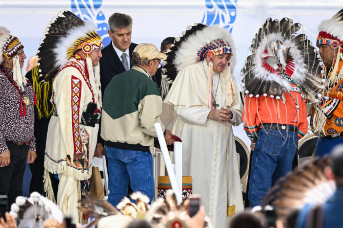 Pope Francis dons a headdress presented to him during his visit to Maskwa Park, Alberta, Canada, on July 25, 20222. 
