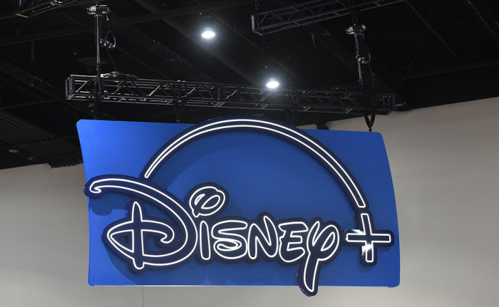 The logo of the Disney+ streaming service hangs above their booth during San Diego Comic-Con International in San Diego, California, on July 24, 2022. 