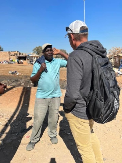 Clint Thomas praying with a man who is a resident of Diepsloot, Johannesburg, South Africa, who needs to find work to provide for his family. 