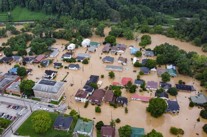 Aerial view of homes submerged under flood waters from the North Fork of the Kentucky River in Jackson, Kentucky, on July 28, 2022. - Flash flooding caused by torrential rains has killed numerous people in eastern Kentucky and left some residents stranded on rooftops and in trees, the governor of the south-central U.S. state said Thursday. 