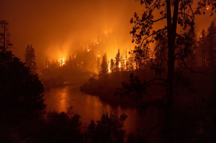 Flames burn to the Klamath River during the McKinney Fire in the Klamath National Forest northwest of Yreka, California, on July 31, 2022. 