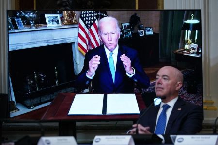 U.S. Homeland Security Secretary Alejandro Mayorkas listens as U.S. President Joe Biden delivers remarks virtually during the first meeting of the interagency Task Force on Reproductive Healthcare Access in the Indian Treaty Room of the Eisenhower Executive Office Building, next to the White House, in Washington, DC, on August 3, 2022. (Photo by MANDEL NGAN / AFP) (Photo by MANDEL NGAN/AFP via Getty Images)