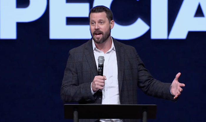 Seth Dillon, the CEO of the conservative Christian news satire site, the Babylon Bee, speaking to an audience of young adults at Virginia’s Cornerstone Chapel Church on Aug. 8, 2022. 