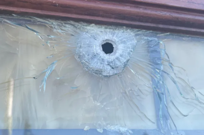 A window shattered by a bullet outside of the Assumption of the Blessed Virgin Mary Catholic Church in Adams County, Colorado.