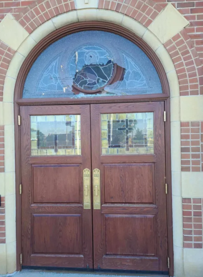A transom stained glass protector was damaged after gunfire targeted the Assumption of the Blessed Virgin Mary Catholic Church in Adams County, Colorado.