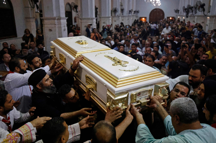 Egyptian mourners attend the funeral of victims killed in Cairo Coptic church fire at the church of the Blessed Virgin Mary in the Giza Governorate on August 14, 2022. Funerals were held in two Cairo churches for 41 victims of a fire that ripped through a Coptic Christian church during Sunday mass, forcing worshippers to jump out of windows. 