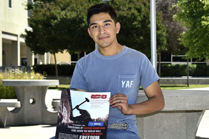 Alejandro Flores, the president of Clovis Community College's chapter of Young Americans for Freedom, holds one of the flyers his group posted on campus that was later removed by school administrators. 