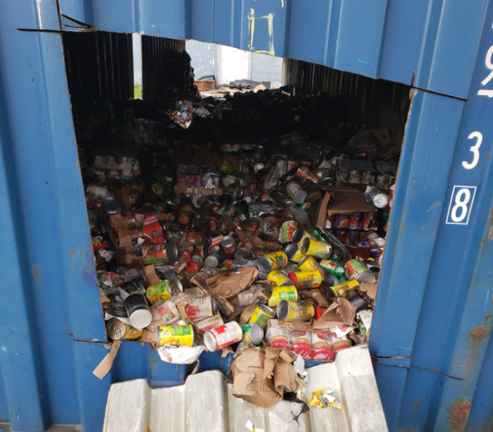 Non-perishable food sits in a shipping container at Harvest Time Christian Church in Warren, Michigan, after a fire on Aug. 14, 2022. 