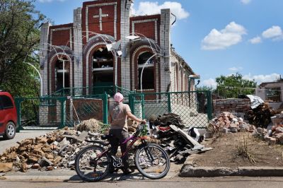 Worshippers leave Sunday service at Sukovska Baptist church on June 19, 2022, in Druzhkivka, Ukraine. Services were held in a small tent in the back of the church because the building was heavily damaged by a recent missile strike. In recent weeks, Russia has concentrated its firepower on Ukraine's Donbas region, where it has long backed two separatist regions at war with the Ukrainian government since 2014. 