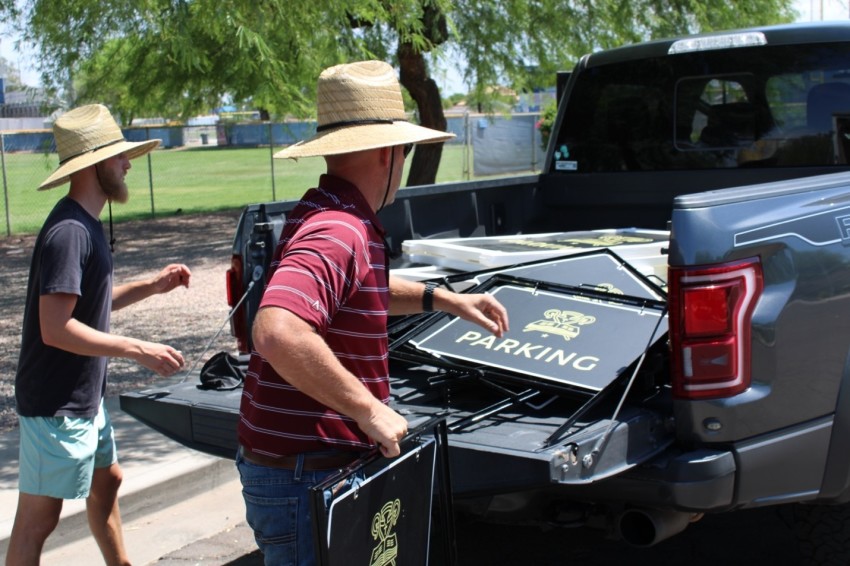Members of the Shepherd's House parking team take down signs during the church's final service in July 2022.